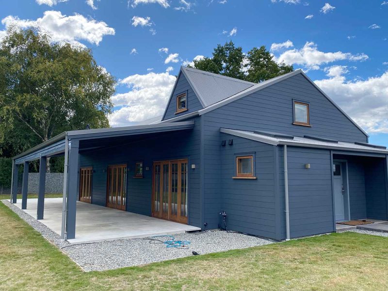 grey exterior painted house in queenstown with wooden timber window frames. Painting by P&P queenstown painters